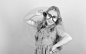 Fashion eyewear. Kid girl heart shaped eyeglasses. Girl adorable smiling face fall in love. Child charming smile blue