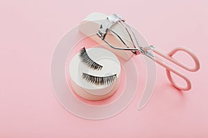 Fashion fake false eyelash with curler on pink background