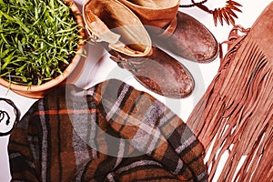 Fashion flat lay with autumnal clothing - scarf, boots, bag, bright wooden accessories. Beautiful cozy trend collection