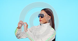 Fashion, future and metaverse with a woman in a vr headset isolated on a blue background in studio. Virtual reality