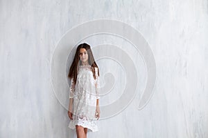 Fashion girl 12 years old in a white dress