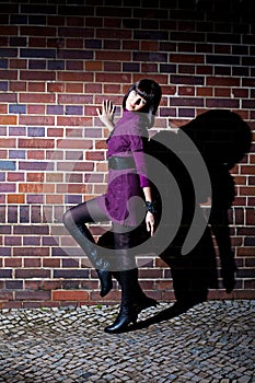 Fashion girl and brick wall