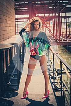 Fashion girl in high heels bikini and summer tunic outdoor
