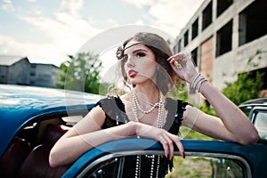 Fashion girl model with bright makeup in retro style and vintage car