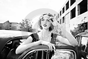 Fashion girl model with bright makeup in retro style and vintage car