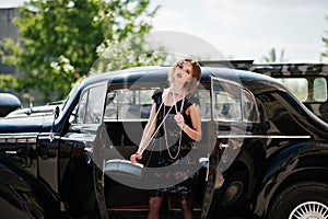 Fashion girl model with bright makeup in retro style and vintage car