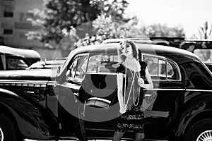 Fashion girl model with bright makeup in retro style and vintage car