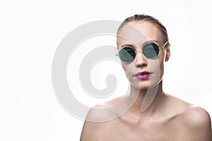 Fashion girl model in green sunglasses isolated on white background looking at the camera. Studio shot.