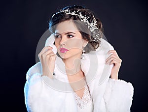 Fashion girl model in white fur coat, luxury jewelry, elegant ha