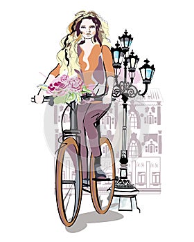Fashion girl rides a bicycle
