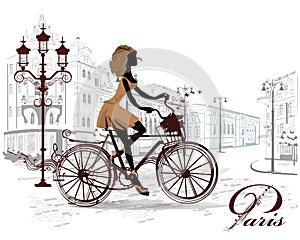 Fashion girl rides a bicycle, decorated with a musical stave photo