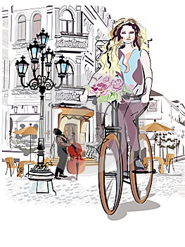 Fashion girl rides a bicycle the streets of the old town.