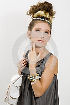 Fashion girl showing jewels and handbag
