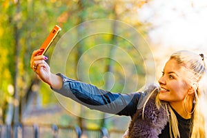 Fashion girl take selfie photo in autumn park