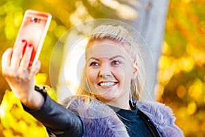 Fashion girl take selfie photo in autumn park