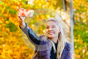 Fashion girl take selfie photo in autumn park