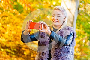 Fashion girl take selfie photo in autumn park