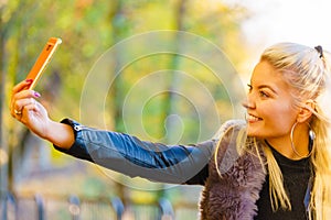Fashion girl take selfie photo in autumn park