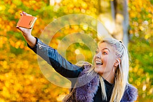 Fashion girl take selfie photo in autumn park