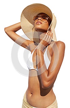 Fashion girl wearing a sun hat, sunglasses and bikini, African latin American woman isolated on white background. Concept of a