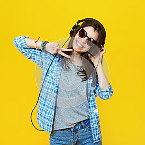 Fashion girl wearing a sunglasses and headphones