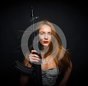 fashion glamour woman holding up her weapon assault rifle g