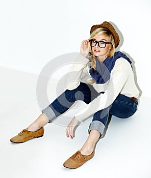 Fashion, glasses and young woman in a studio with a trendy, cool and stylish outfit and accessories. Confident, portrait