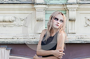 A fashion gothic style portrait of a beautiful blonde girl