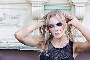 A fashion gothic style portrait of a beautiful blonde girl