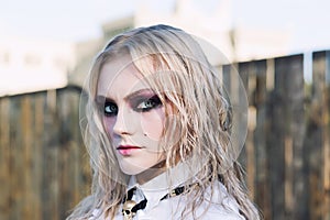 A fashion gothic style portrait of a beautiful blonde girl