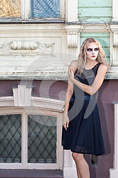 A fashion gothic style portrait of a beautiful blonde girl