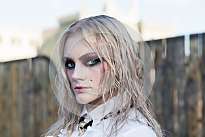 A fashion gothic style portrait of a beautiful blonde girl