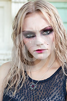 A fashion gothic style portrait of a beautiful blonde girl