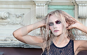 A fashion gothic style portrait of a beautiful blonde girl