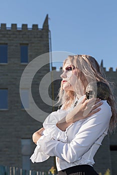 A fashion gothic style portrait of a beautiful blonde girl