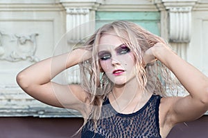 A fashion gothic style portrait of a beautiful blonde girl