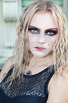 A fashion gothic style portrait of a beautiful blonde girl