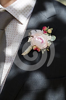 Groom with rose boutonniere on wedding