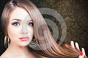 Fashion hairstyle. Beautiful woman with long straight hair