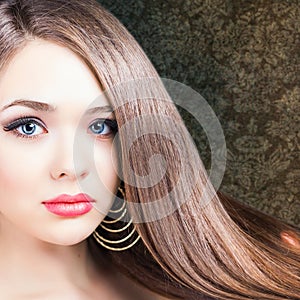 Fashion hairstyle. Beautiful woman with long straight hair