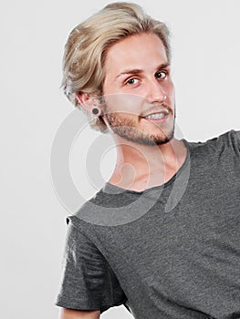 Happy smiling blonde man in grey t shirt