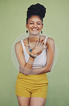 Fashion, happy and carefree with a model black woman in studio on a green background for trendy style. Laugh, funny and