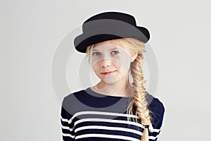 Fashion, happy and portrait of child in a studio with casual, cool and stylish outfit and hat. Smile, youth and young