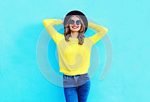 Moda Contento carino donna sorridente logorante nero un cappello un lavorato maglia un maglione Attraverso colorato blu 