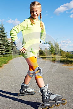 Fashion happy smiling hipster cool girl in colorful clothes with roller skates