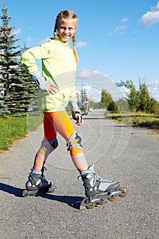 Fashion happy smiling hipster cool girl in colorful clothes with roller skates