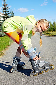 Fashion happy smiling hipster cool girl in colorful clothes with roller skates
