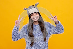 Fashion happy young woman in knitted hat and sweater having fun over colorful blue background. Happy face, positive and