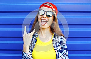 Fashion hipster cool girl in sunglasses and colorful clothes having