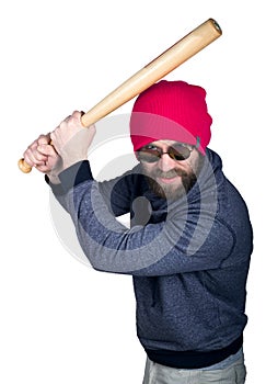 Fashion hipster cool man in sunglasses and colorful clothes brandishing a baseball bat